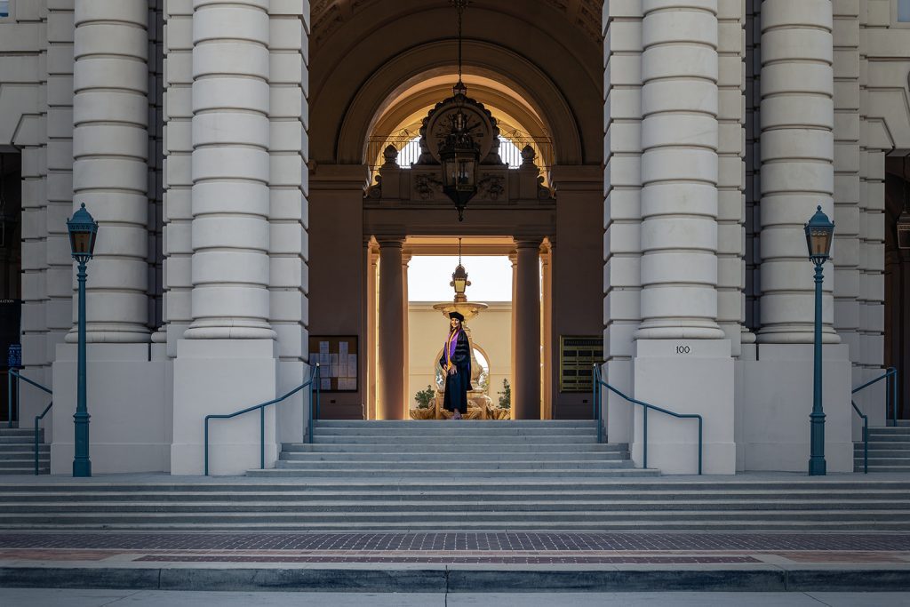 A wedding photographer is descending the steps of a building in Los Angeles.