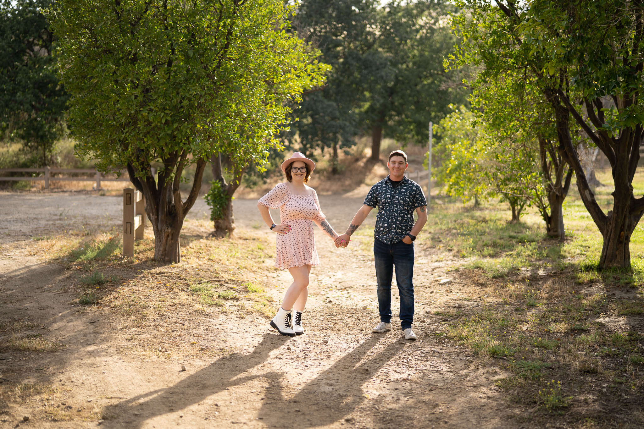 ThomasKim_photography K & S Engagement Session: A couple holding hands on a dirt path.
