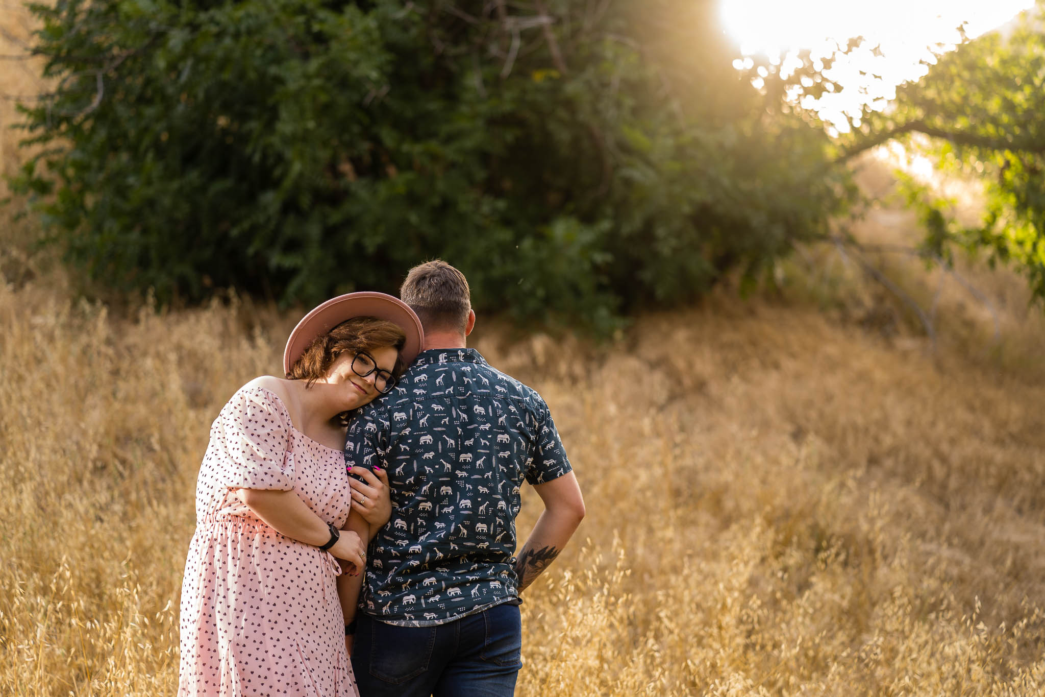 ThomasKim_photography K & S Engagement Session featuring a couple hugging in a grassy field.