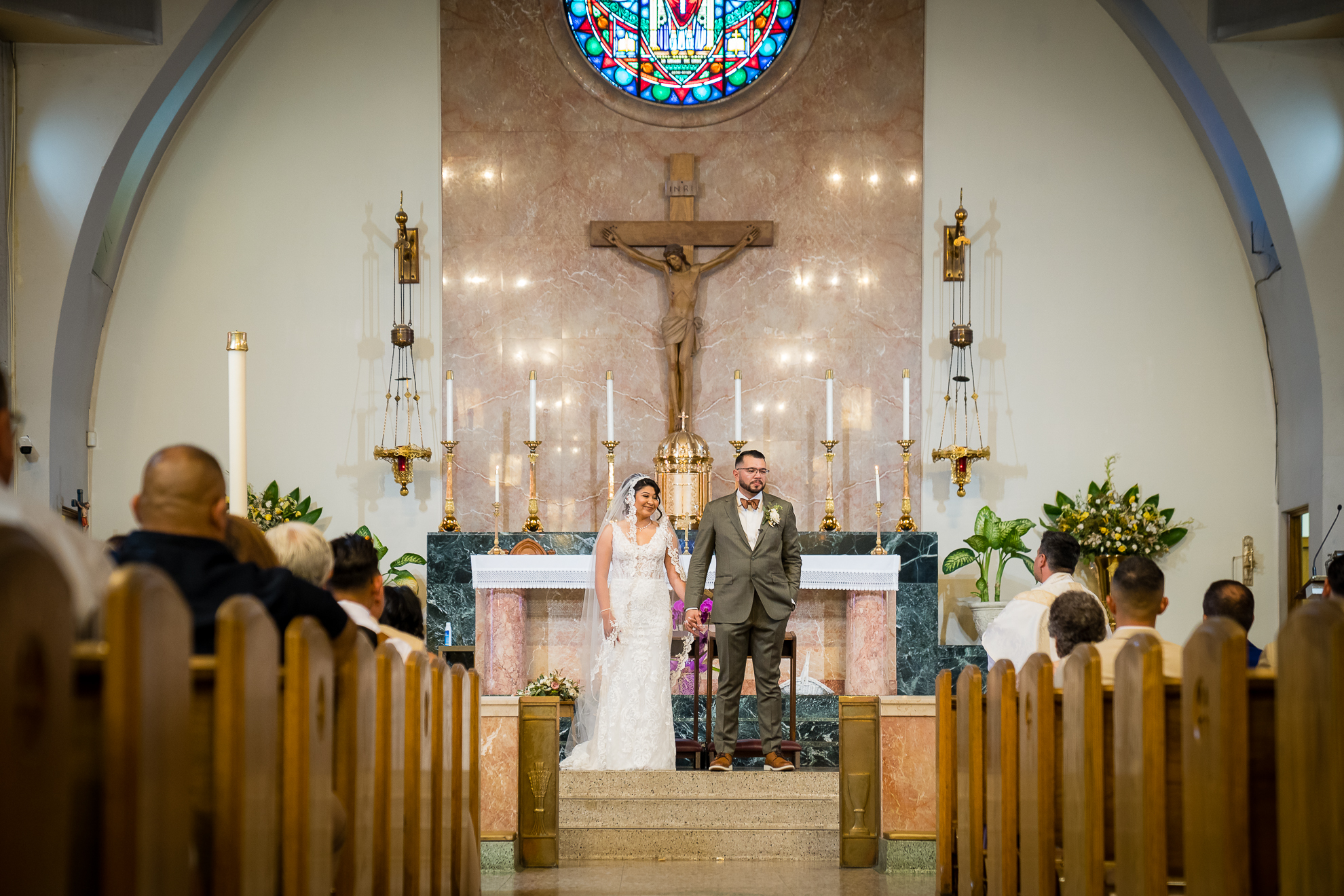 ThomasKim_photography A bride and groom standing in the Aisle of a church.