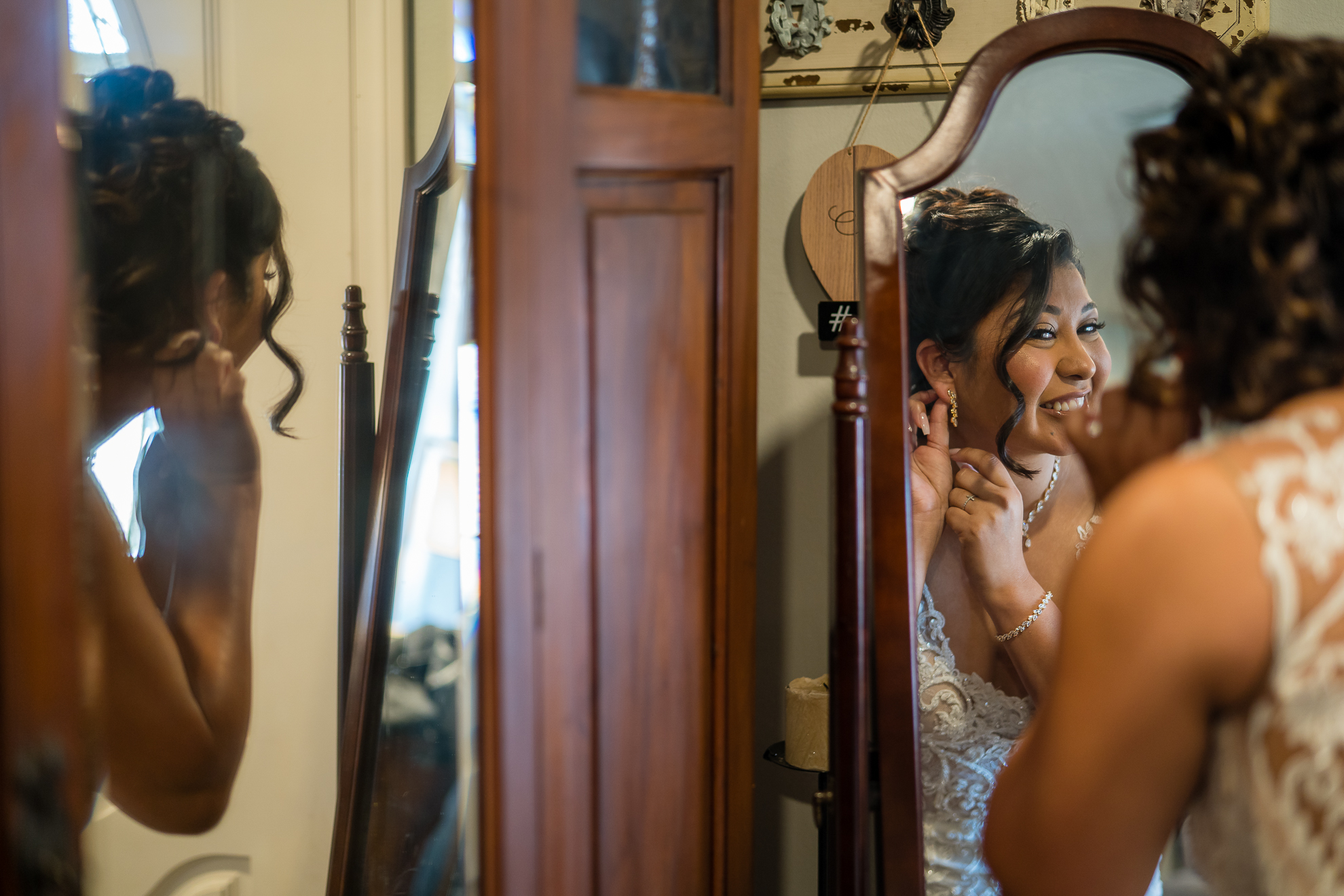 ThomasKim_photography A bride getting ready in front of a mirror for her special day.