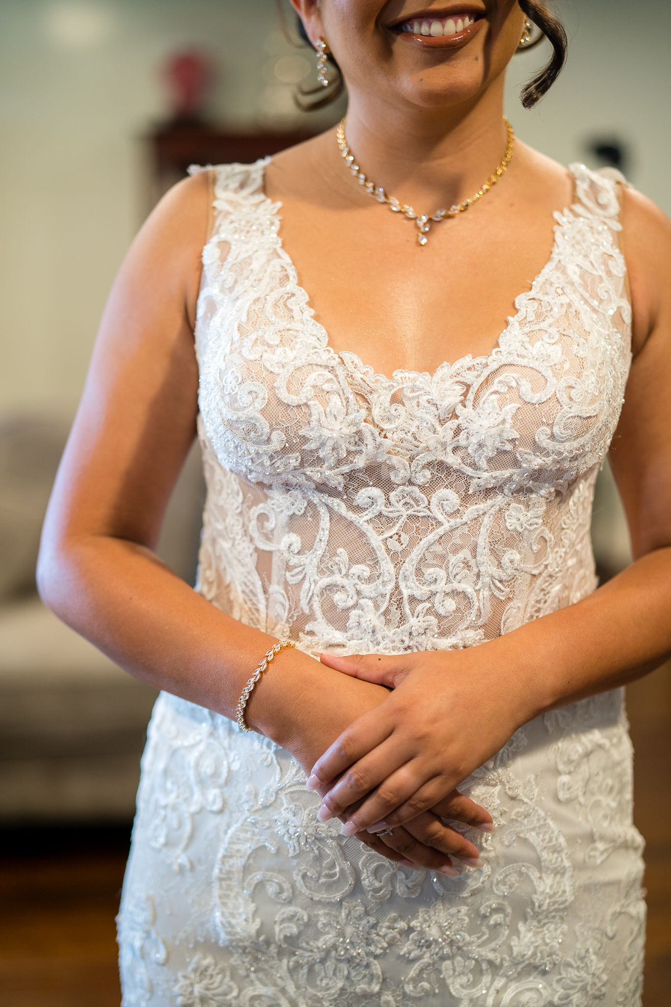 ThomasKim_photography A bride in a lace wedding dress smiles for the camera. (S)