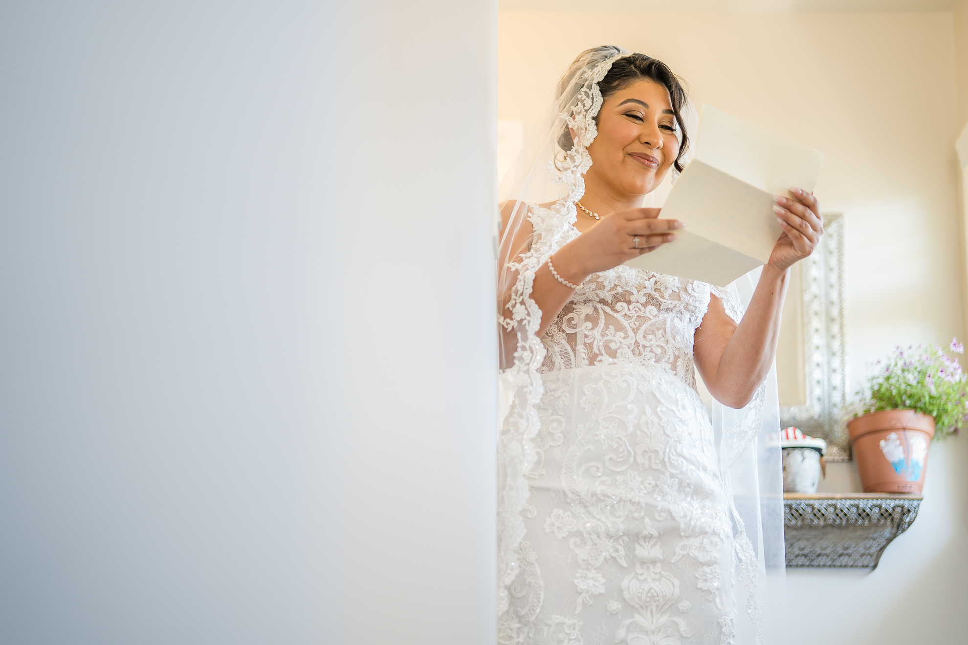 ThomasKim_photography A bride in a wedding dress reading a love letter.
