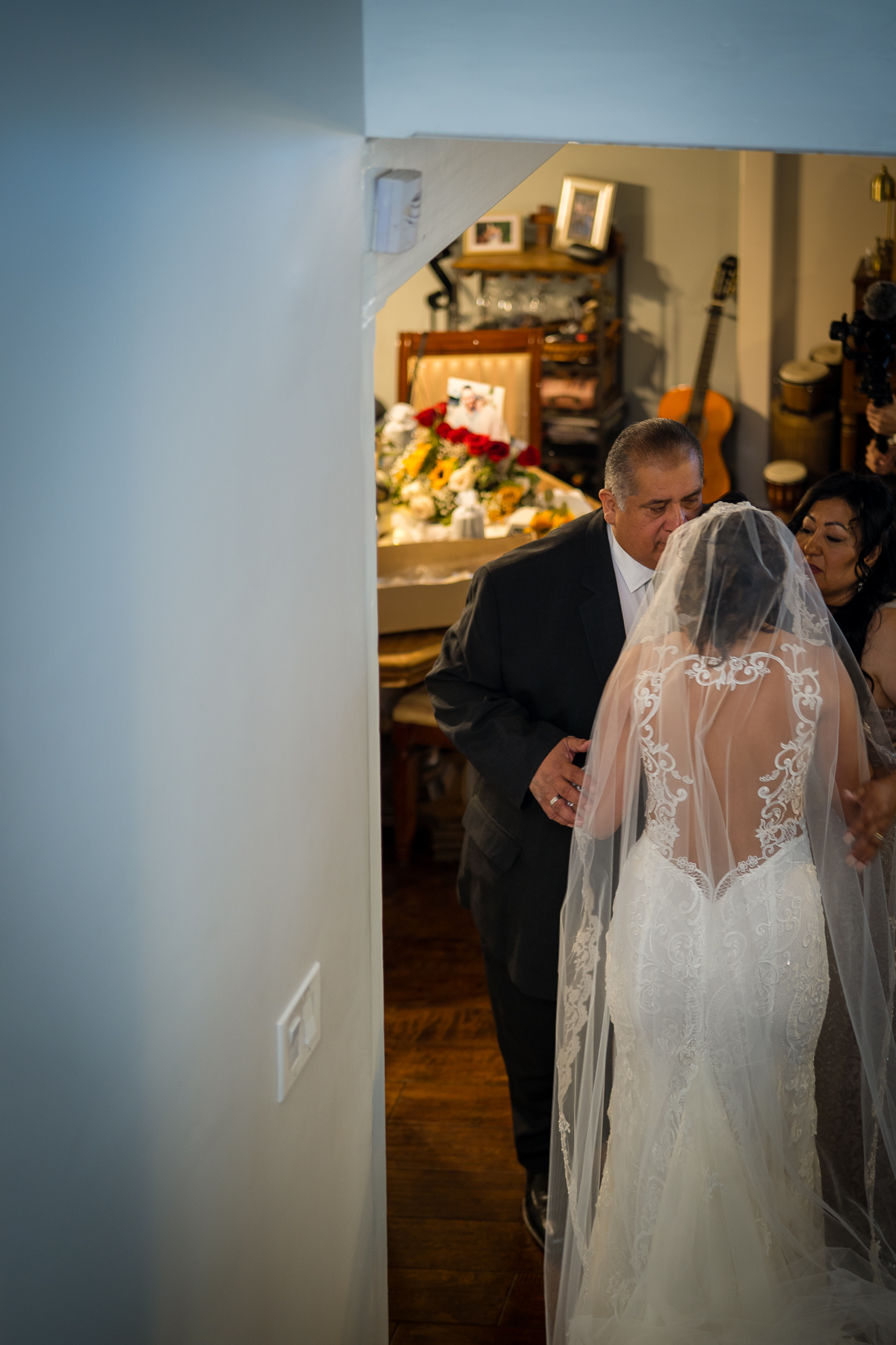 ThomasKim_photography A bride walks down the hallway with her father during a special occasion.