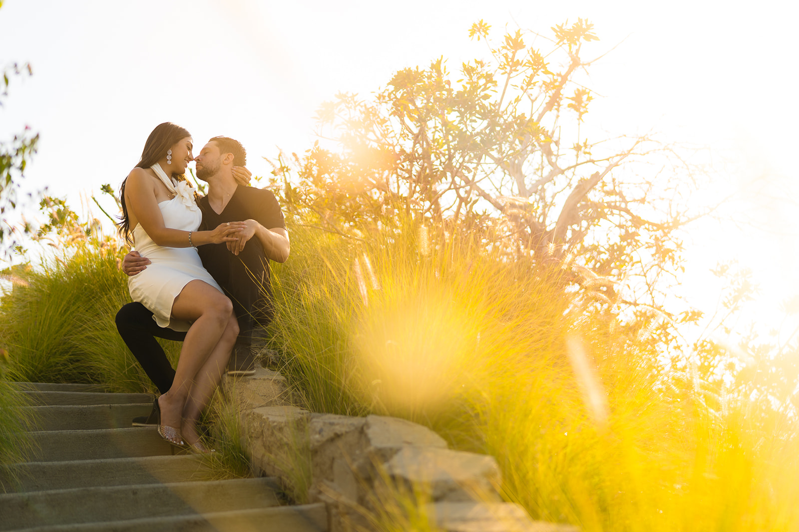 ThomasKim_photography A couple sits on a set of stairs for their V & J engagement session.