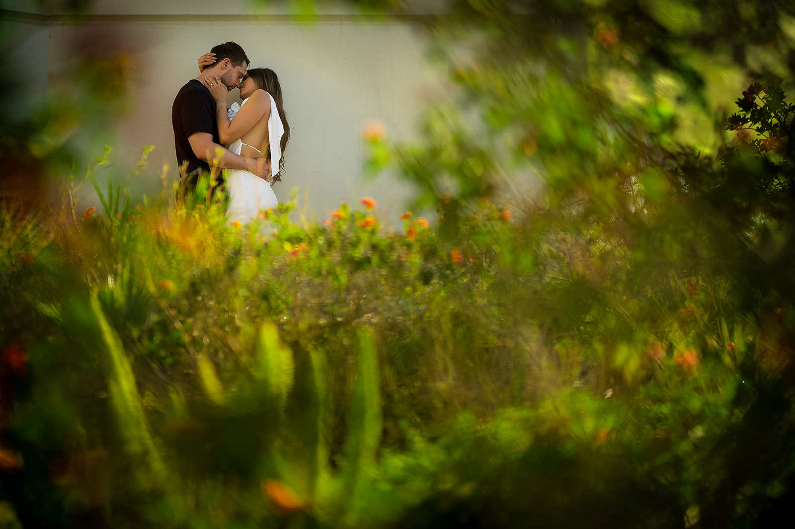 ThomasKim_photography V & J Engagement Session: A couple kissing in a garden.